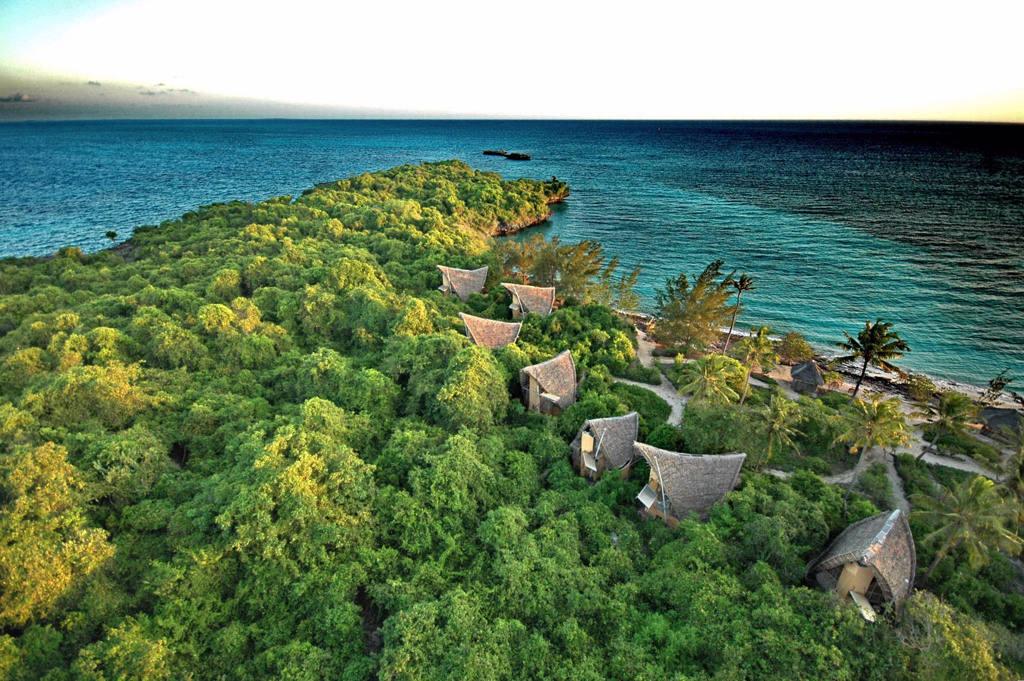 Several eco-resort bungalows nestled in the greenery of Chumbe Island Zanzibar