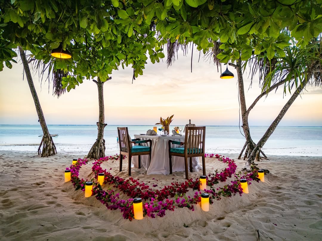 A romantic white-sand Zanzibar beach at sunset near luxury resort