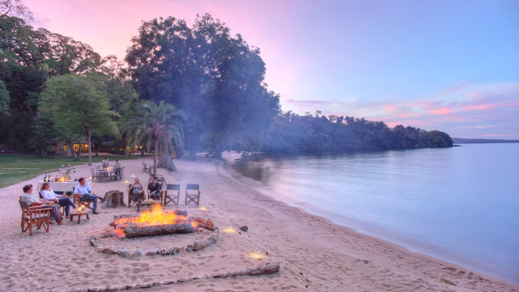 Tourist relaxing by the calm waters of Rubondo Island National Park Tanzania