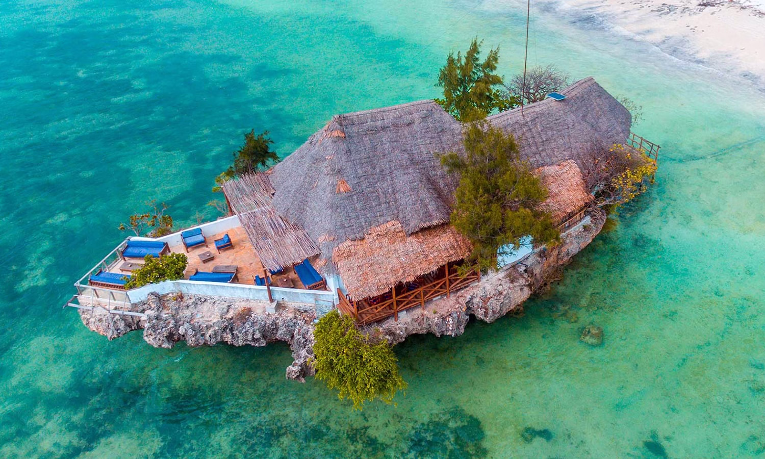 Aerial photo of The Rock Restaurant Zanzibar surrounded by turquoise Indian Ocean waters