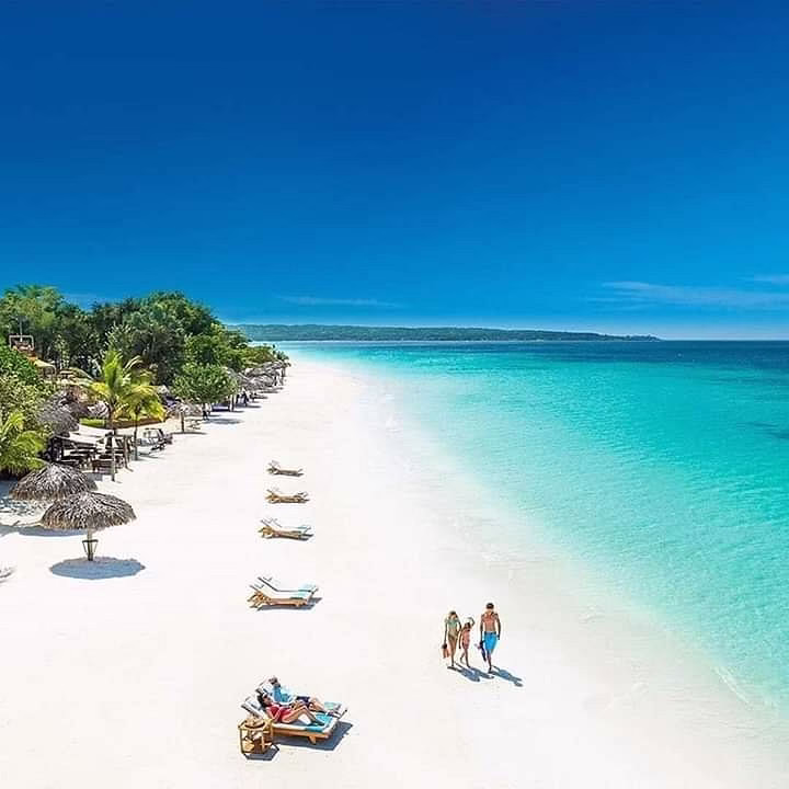 Tourists relaxing and walking along Paje Beach during the daytime in Zanzibar